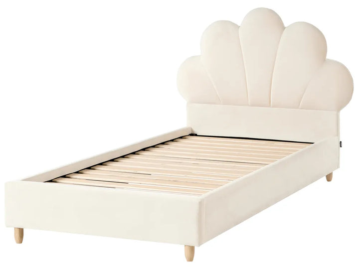 Beige bed with shell-shaped headboard on a white background
