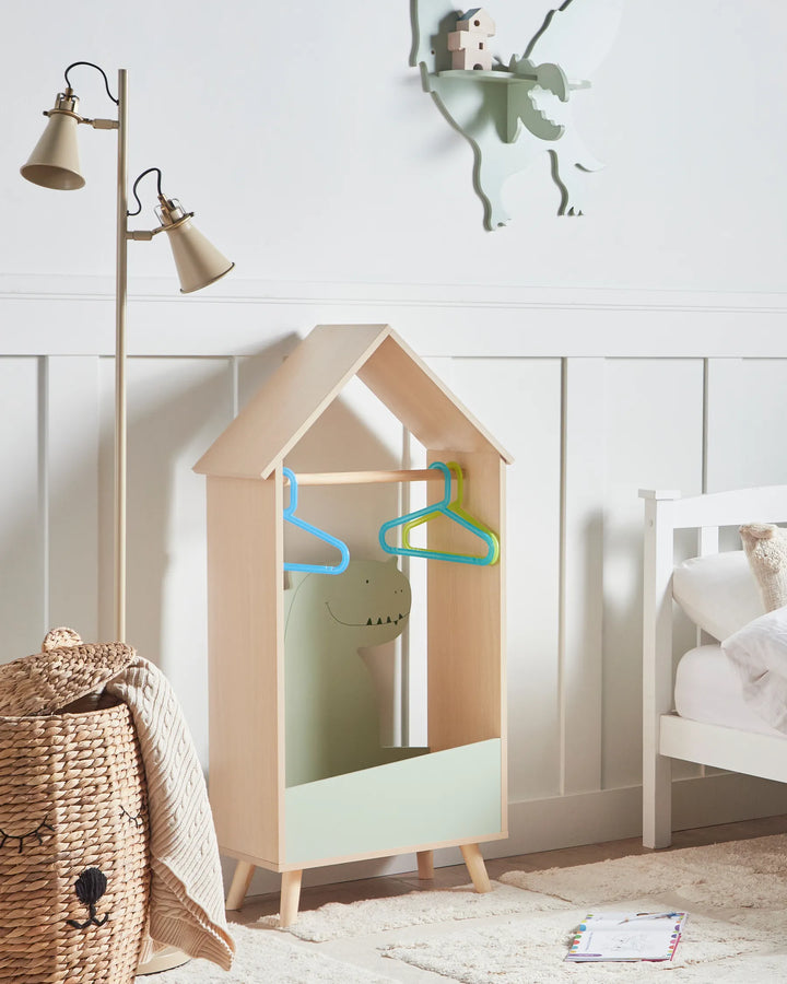 Children's room with a house-shaped wardrobe, lamp, and bed.
