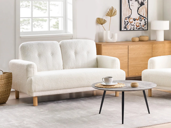 Modern white boucle sofa with padded seat and retro design