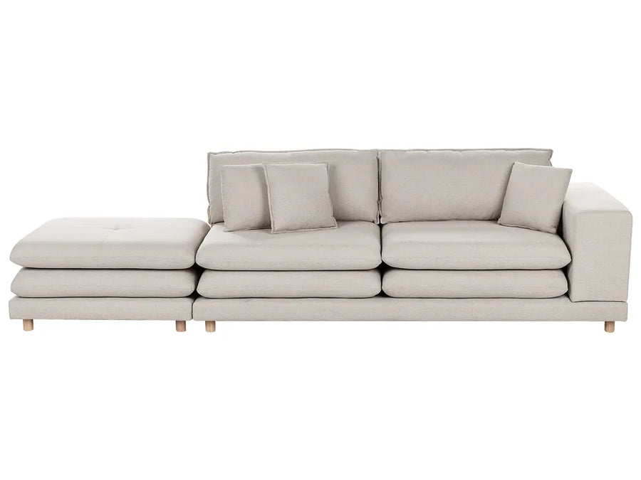 Beige sofa with chaise lounge on a white background
