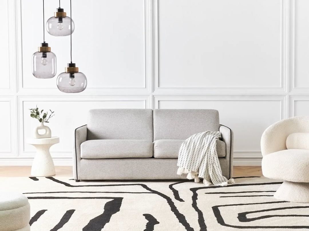 Modern grey fabric sofa bed with cushioned seat and backrest