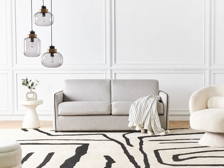 Modern grey fabric sofa bed with cushioned seat and backrest