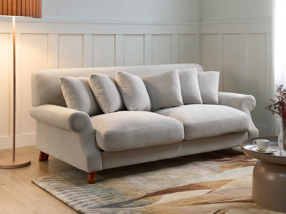 Gray sofa in a living room with a lamp and coffee table.