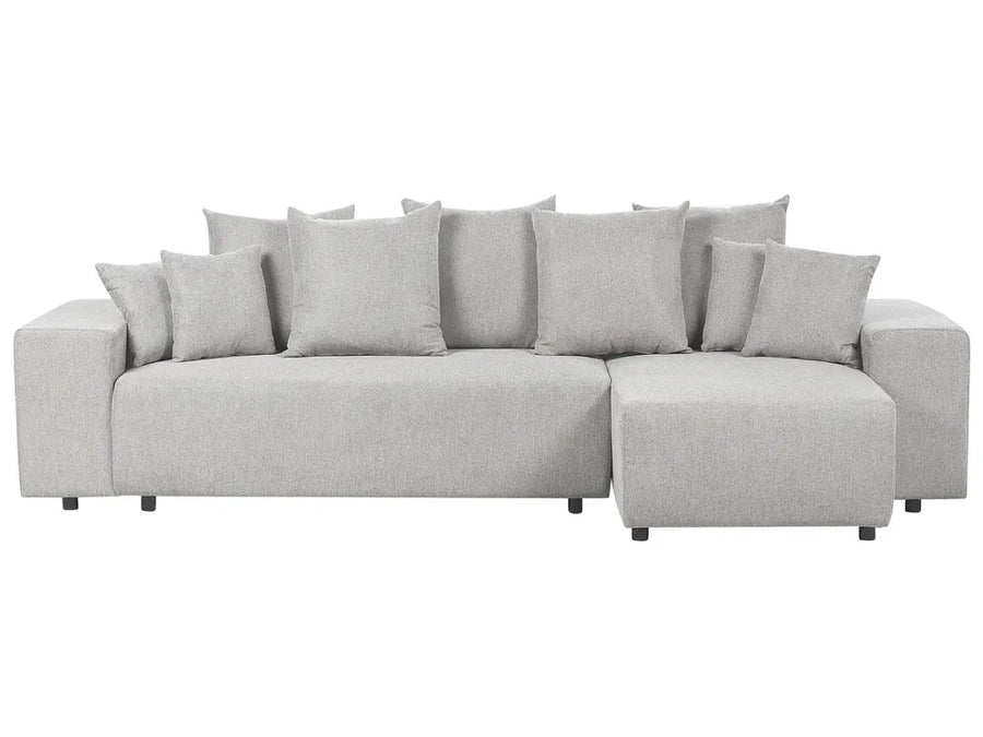 Gray sectional sofa with multiple cushions on a white background