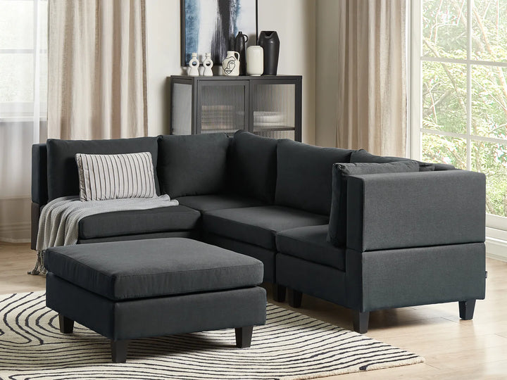 Gray sectional sofa in a living room setting with decor elements.