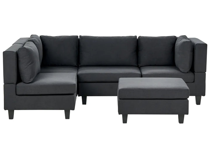Gray sectional sofa with ottoman on a white background