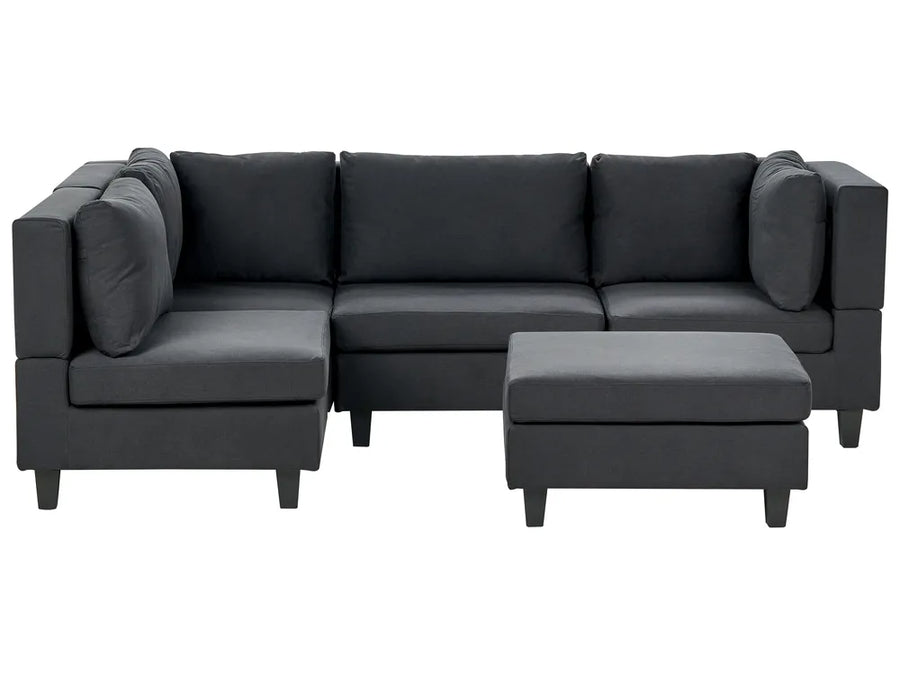 Gray sectional sofa with ottoman on a white background