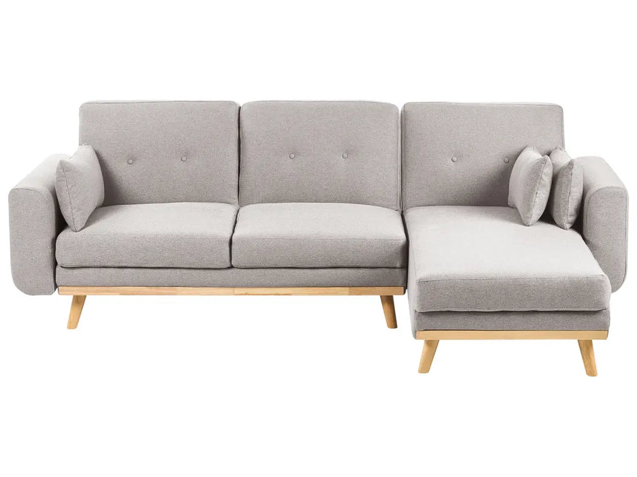 Gray sectional sofa with wooden legs on a white background