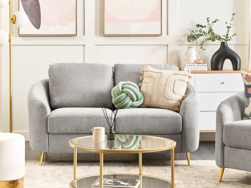Gray sofa with decorative pillows in a living room setting