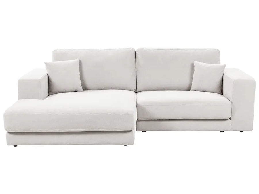 Light gray sectional sofa with cushions on a white background