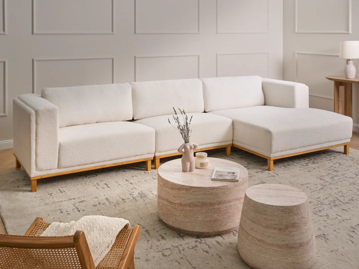 Left hand off-white fabric corner sofa with wooden legs