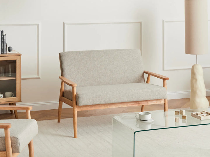Beige sofa with wooden frame in a minimalistic living room setting