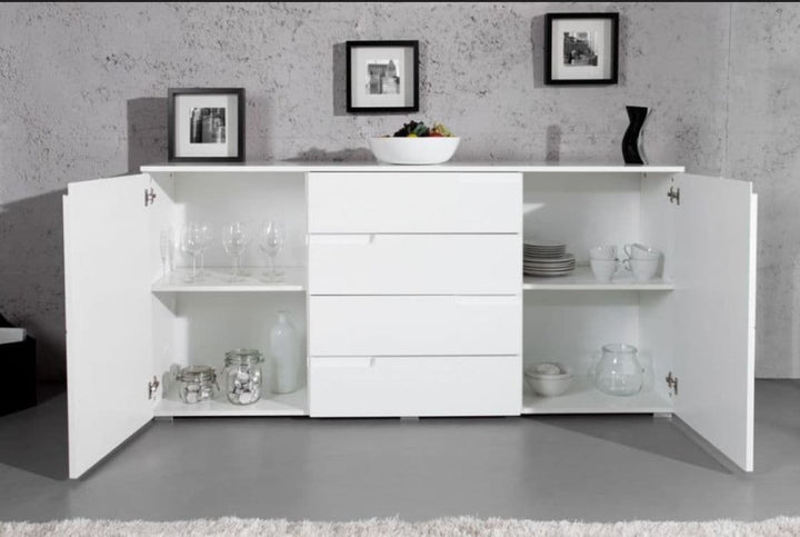 White sideboard with open doors displaying various items against a gray wall.