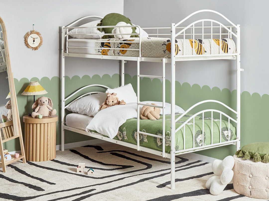 White metal bunk bed in a child's bedroom with green accents and toys.