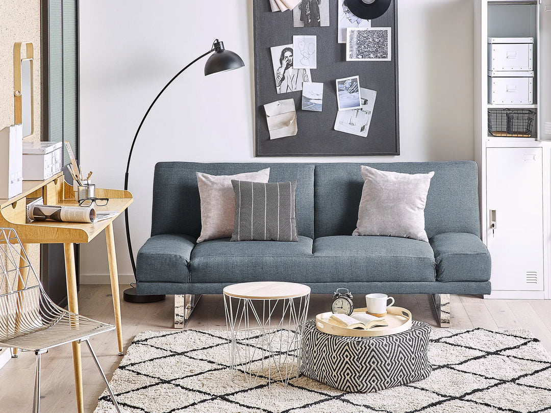 blue fabric sofa bed with wooden frame and metal legs