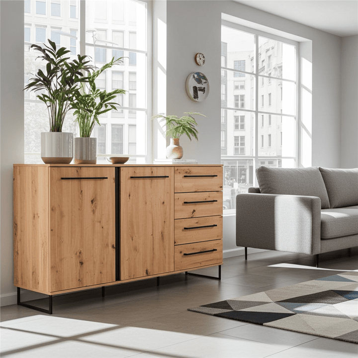 Wooden sideboard in a modern living room with a gray sofa and large windows.