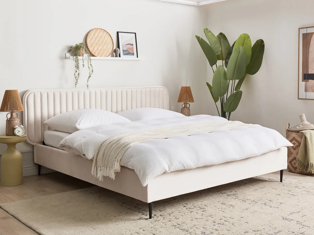 Neatly made bed in a bedroom with decor elements.
