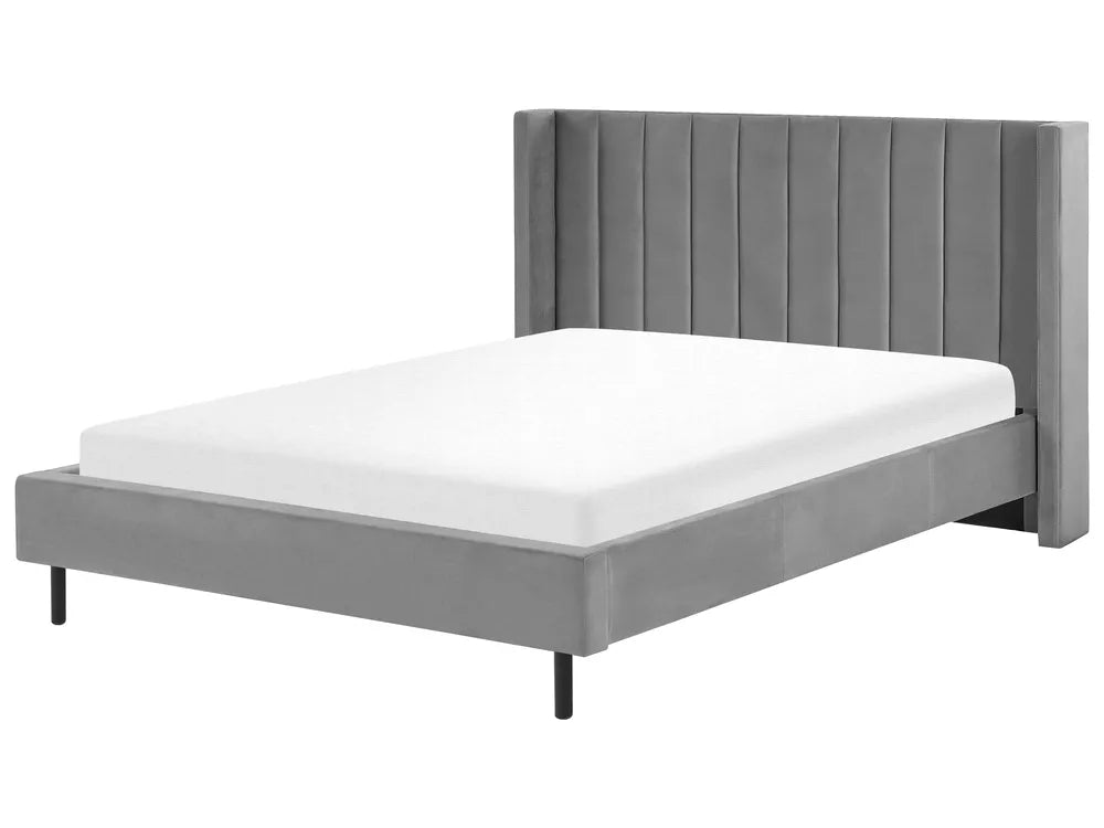 Gray upholstered bed with white mattress on a white background
