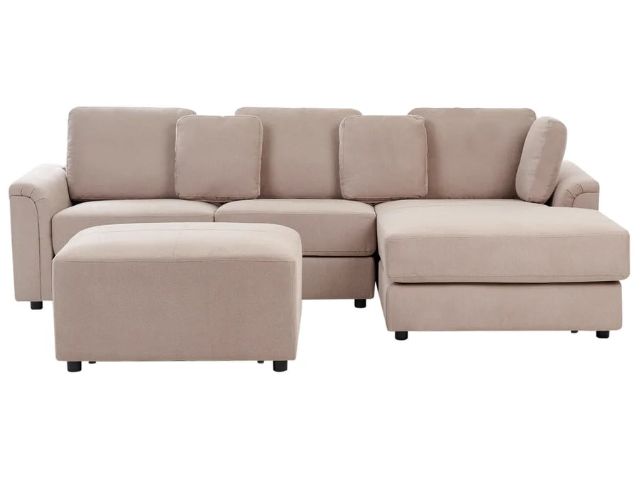 Beige sectional sofa with a matching ottoman on a white background
