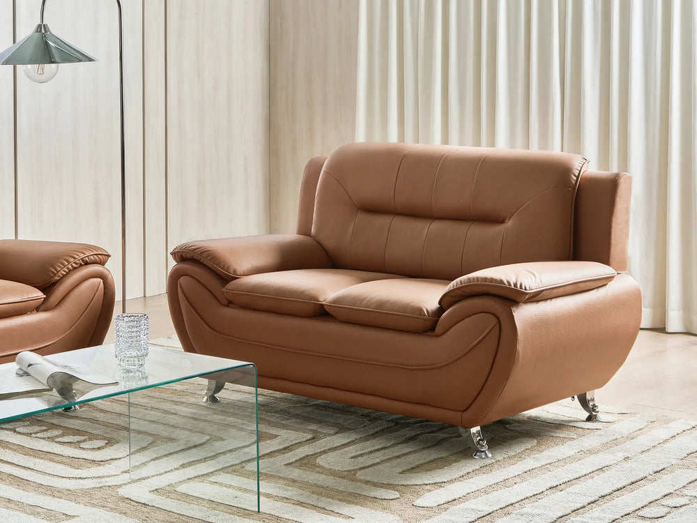 Brown leather sofa in a living room setting with a glass coffee table.