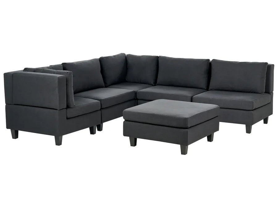 Gray sectional sofa with ottoman on a white background