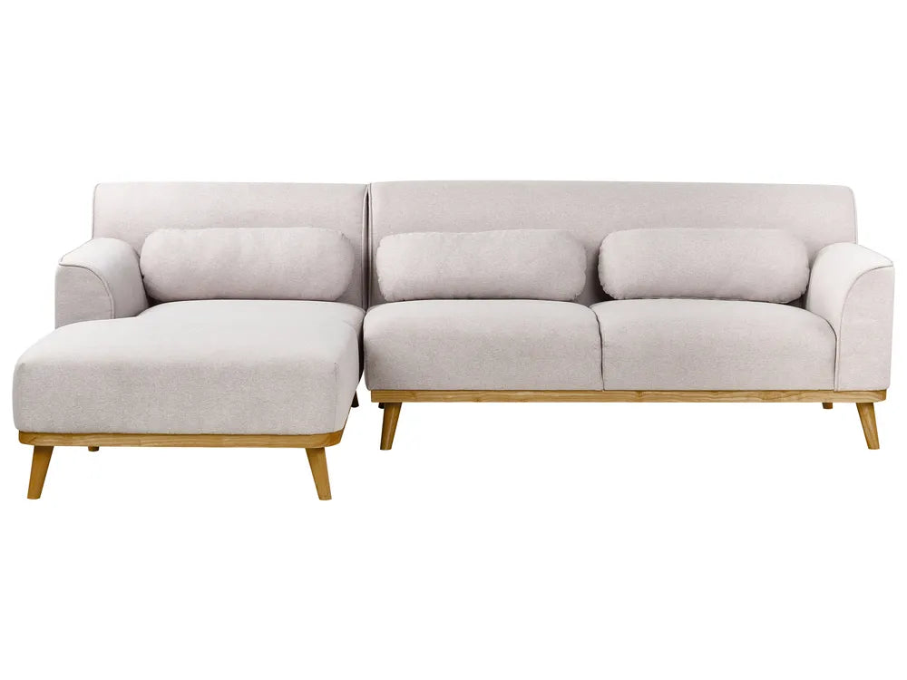 Light gray sectional sofa with wooden legs on a white background