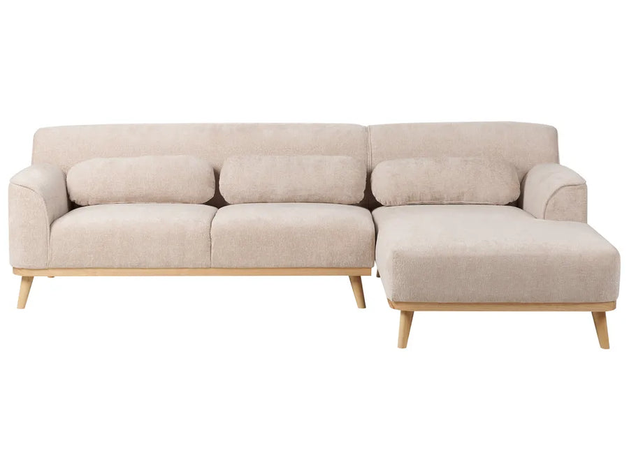 Beige sectional sofa with wooden legs on a white background