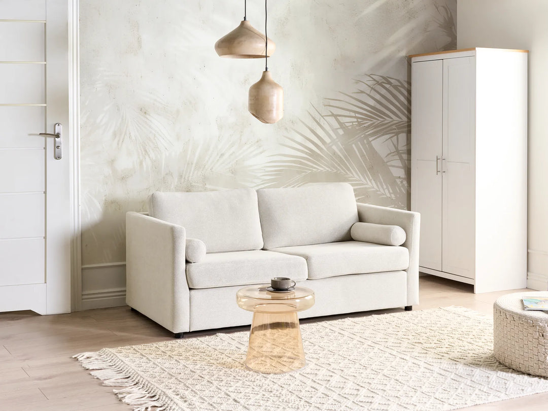 Modern living room with a white sofa, coffee table, and wardrobe.