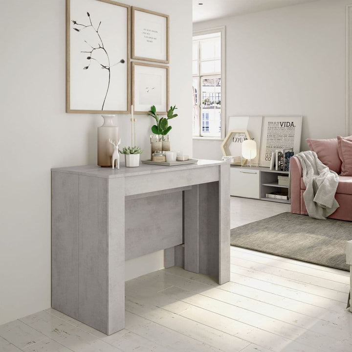 Modern interior with a gray console table, pink sofa, and decorative elements.