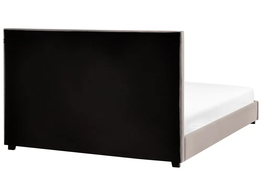 Bed frame with black headboard and white mattress on a white background