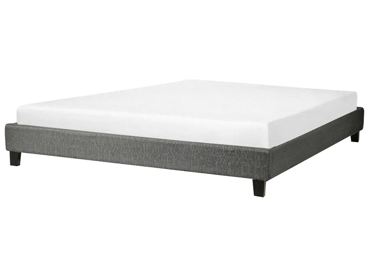 Bed with gray frame and white mattress on a white background