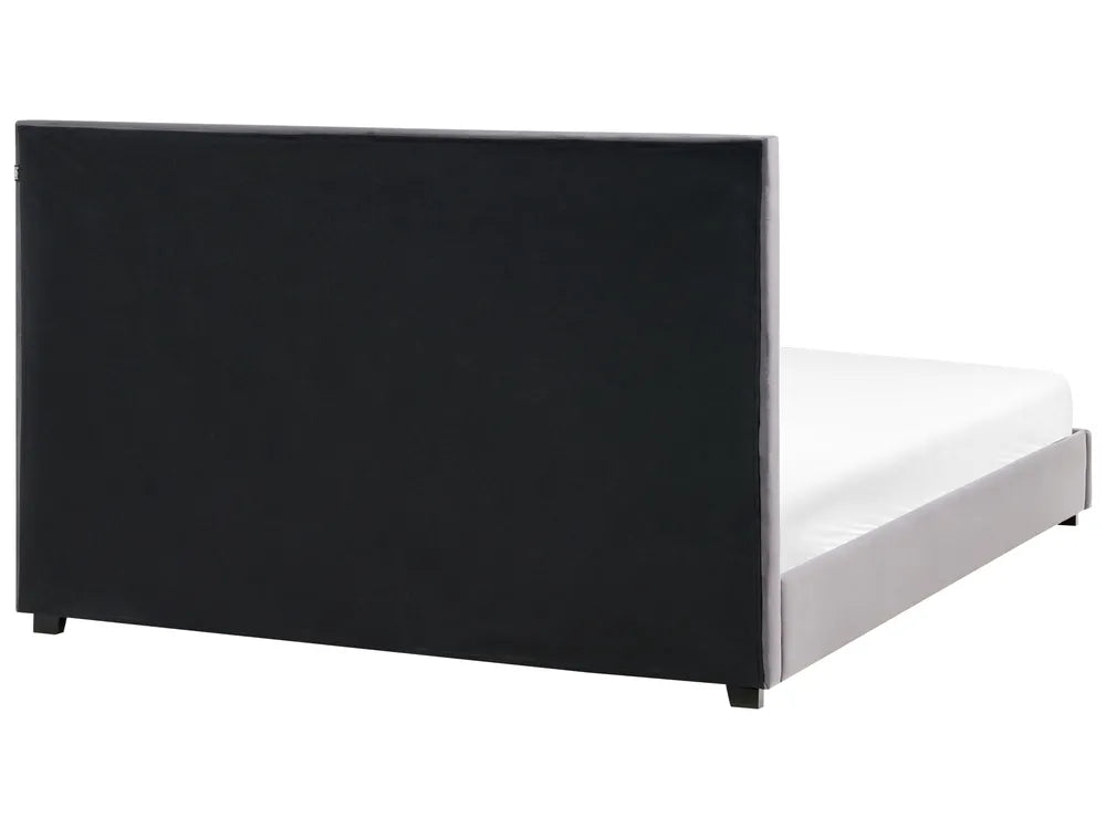 Black bed frame with white mattress on a white background
