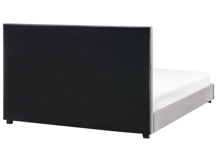 Black bed frame with white mattress on a white background