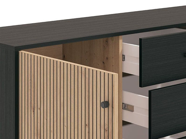 Close-up of a wooden cabinet with black and white drawers.