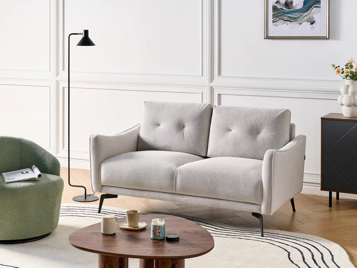 Gray sofa in a modern living room with a wooden coffee table and decorative items.