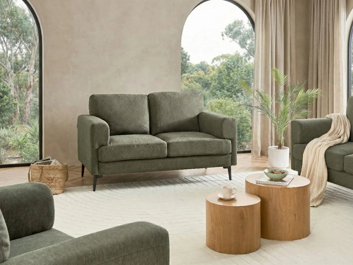 modern green 2 seater sofa with wide arms and fabric upholstery