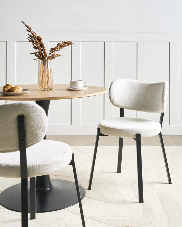 Contemporary dining area featuring elegant fabric chairs that offer comfort, softness, and a refined minimalist look.