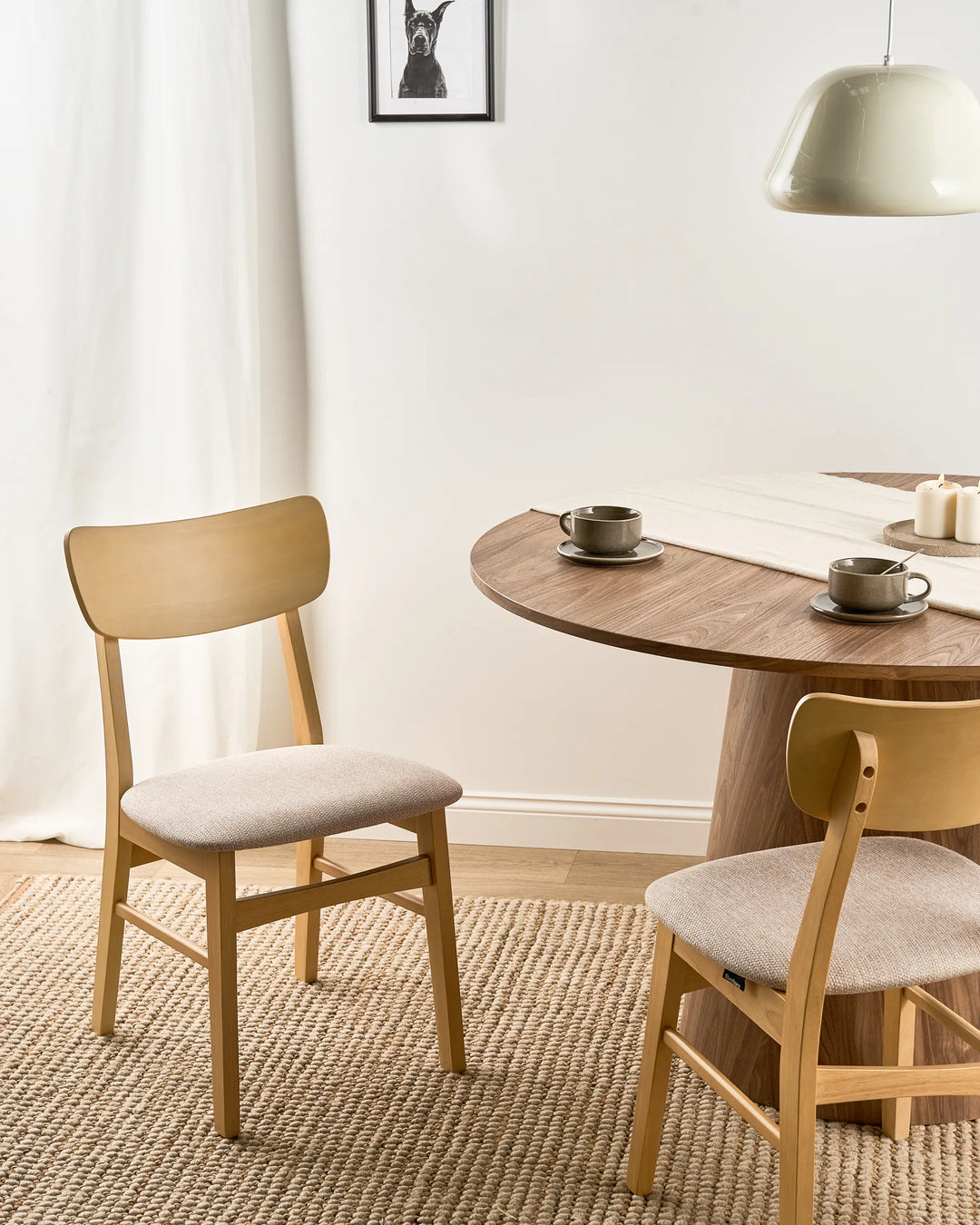 Natural wood woven dining chairs styled in a bright, cozy dining space with soft textures and warm neutral tones, creating an airy, inviting, and relaxed atmosphere.
