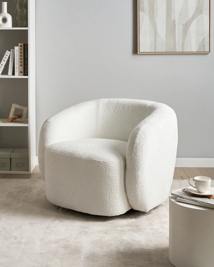 White textured armchair in a modern living room setting with a neutral color palette.