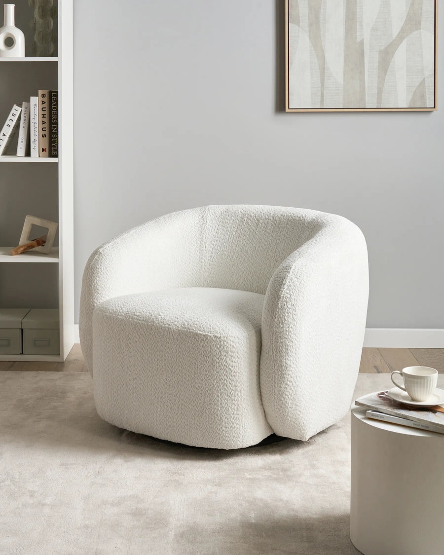 White textured armchair in a modern living room setting with a neutral color palette.
