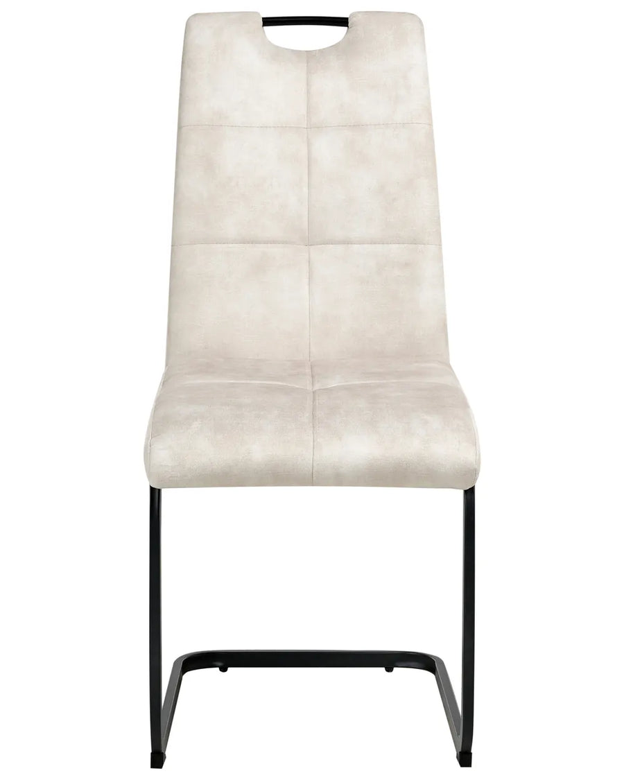Upholstered dining chair in light beige with a high backrest, subtle stitched detailing, integrated handle, and black cantilever metal base.