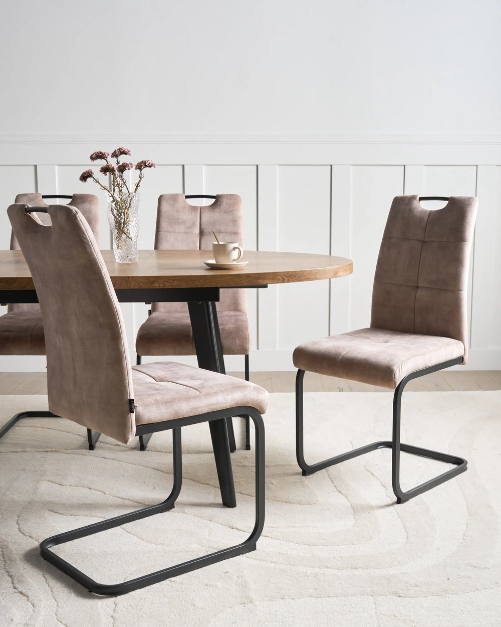 Elegant dining chairs in a warm taupe finish, combining comfort and modern design to create a sophisticated dining setting.