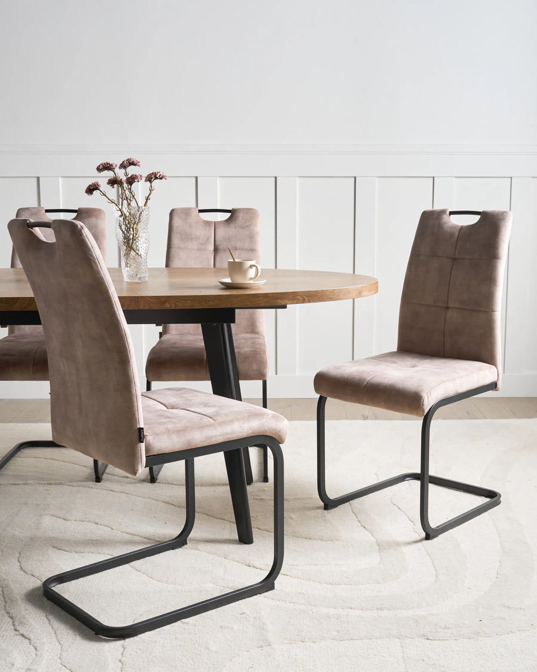 Elegant dining chairs in a warm taupe finish, combining comfort and modern design to create a sophisticated dining setting.