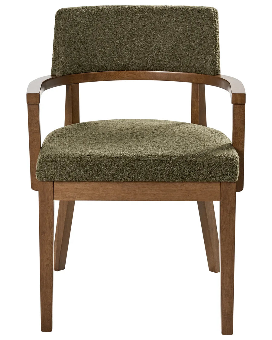 Bouclé dining chair with a curved backrest, wooden armrests, and a warm walnut-finished frame.