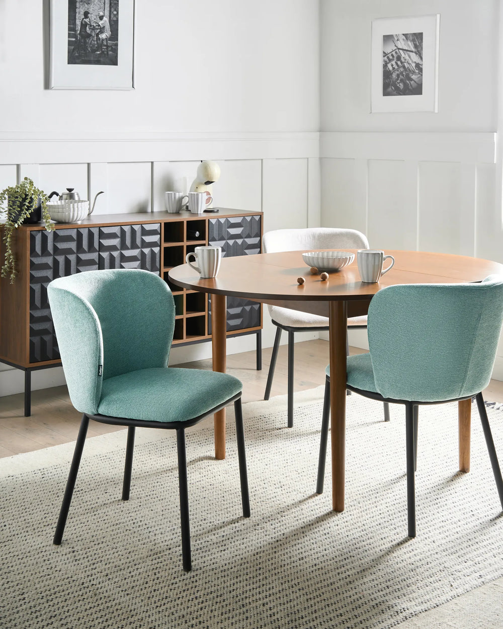 Mint green dining chairs styled around a wooden table, bringing a soft pop of colour to a bright and contemporary dining space.