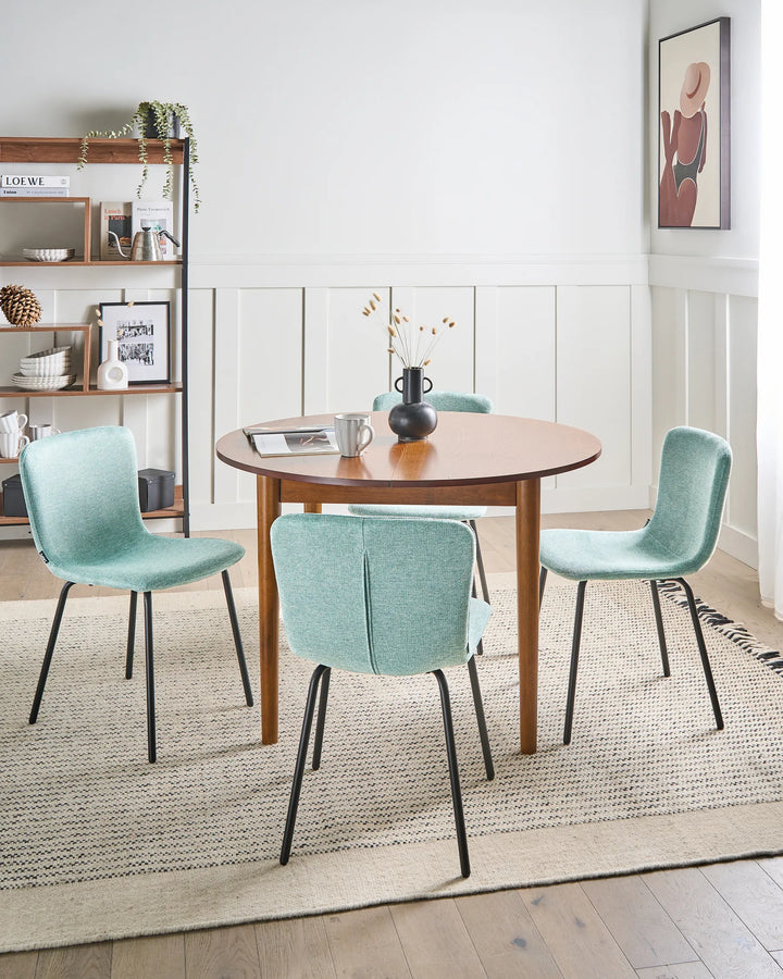 Mint green dining chairs arranged around a wooden table in a bright, contemporary dining room.