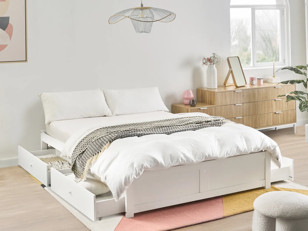 White double storage bed with four drawers, two white bedside cabinets, and modern Scandinavian minimalist bedroom decor on a white background