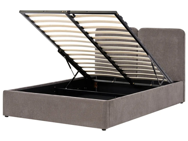 Grey upholstered bed with a black metal frame 
