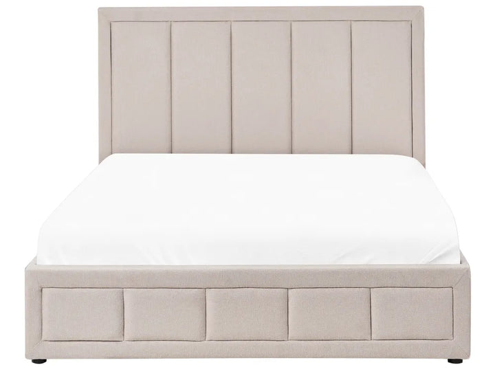Beige upholstered bed with white mattress on a white background