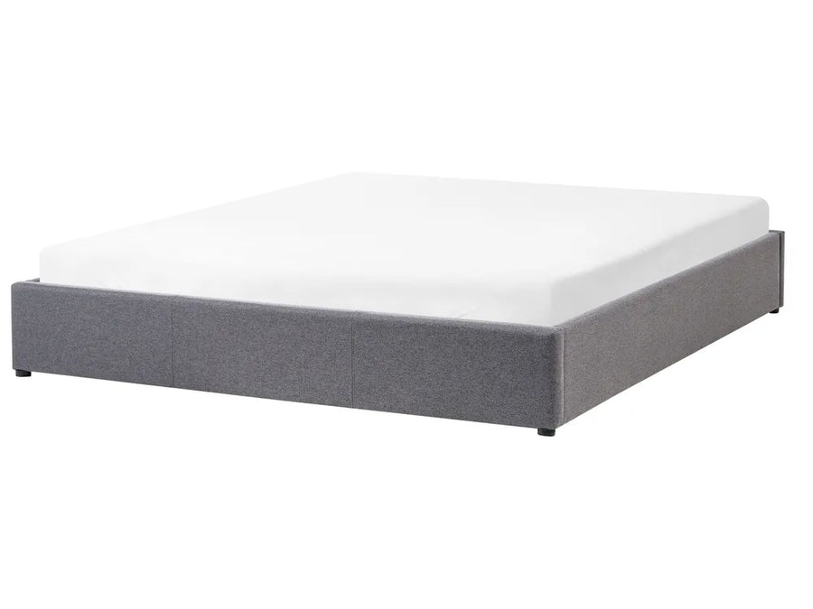 Gray upholstered bed frame with white mattress on a white background